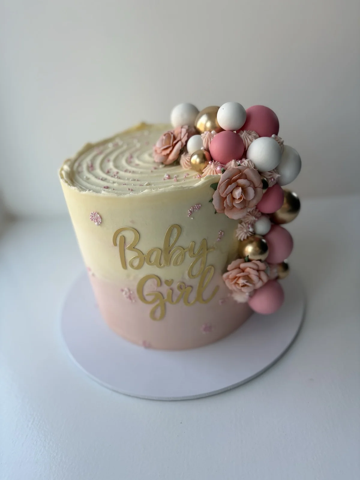 A pink Baby Girl baby shower celebration cake