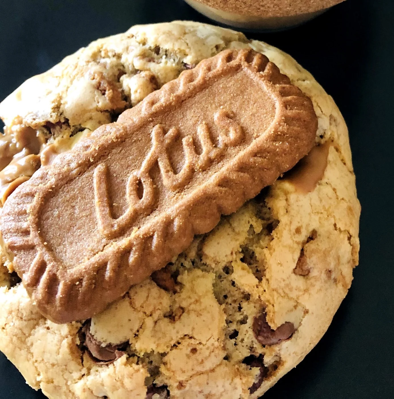 A thick stuffed cookie topped with a Lotus Biscoff biscuit
