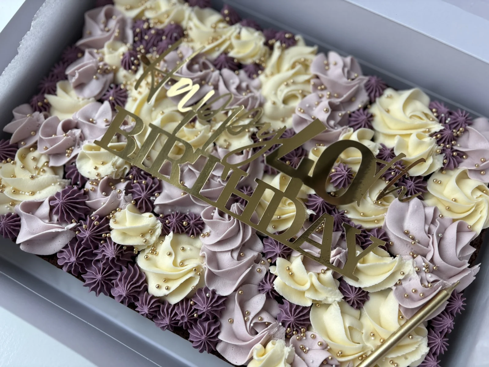 A birthday sheet cake box of buttercream-topped bakes from The Cake Station